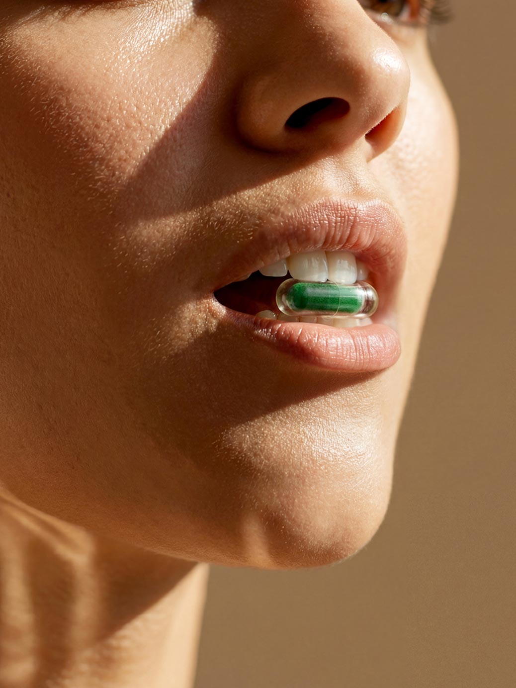 Woman with Rhowell capsule in mouth