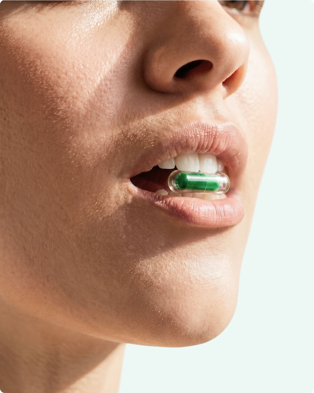 Woman with Rhowell capsule in mouth